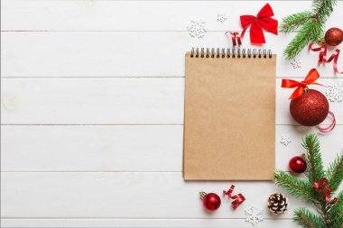 Christmas blank greeting card mock-up scene. Creative layout made of Christmas tree branches and paper card note. Flat lay. Nature New Year concept.