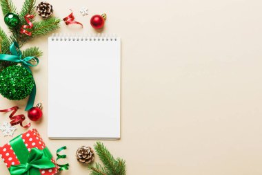 Christmas blank greeting card mock-up scene. Creative layout made of Christmas tree branches and paper card note. Flat lay. Nature New Year concept.