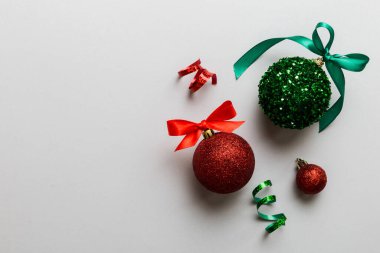 Christmas ball on colored background. decoration bauble with ribbon bow with copy space.