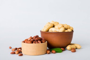 Fresh healthy peanuts in bowl on colored table background. Top view Healthy eating bertholletia concept. Super foods.