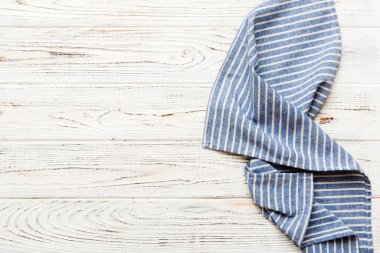 top view with blue kitchen napkin isolated on table background. Folded cloth for mockup with copy space, Flat lay. Minimal style.