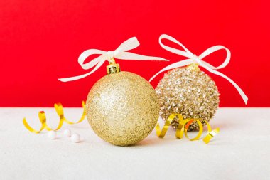 Christmas ball on colored background. decoration bauble with ribbon bow with copy space.