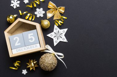 Christmas calendar 25 december. Christmas gift, fir branches, pine cones. Flat lay, top view. New Year decorations on a colored background.