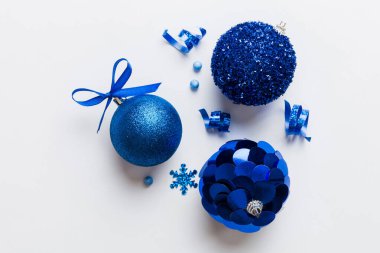 Christmas ball on colored background. decoration bauble with ribbon bow with copy space.