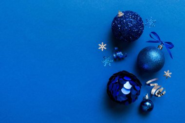 Christmas ball on colored background. decoration bauble with ribbon bow with copy space.