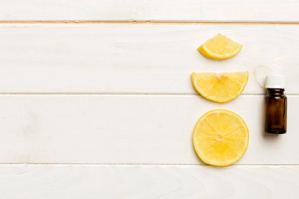 stock image Bottles with lemon fruit essential oil on wooden background. alternative medicine top view with copy space.