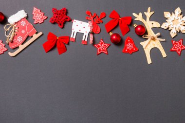 Noel oyuncakları ve süslemeleri olan siyah bir arkaplan. Tasarımınız için boş alanı olan mutlu yıllar konsepti.