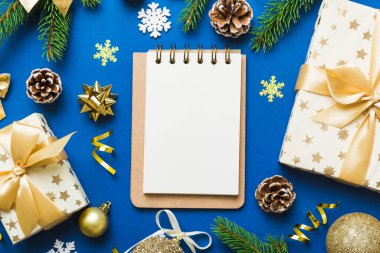 Christmas blank greeting card mock-up scene. Creative layout made of Christmas tree branches and paper card note. Flat lay. Nature New Year concept.