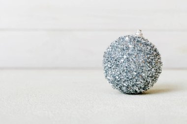 Christmas ball on colored background. decoration bauble with ribbon bow with copy space.