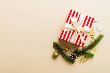 Top view Flat lay Christmas decorations and gift box on colored background with copy space. Christmas or Happy New Year composition.