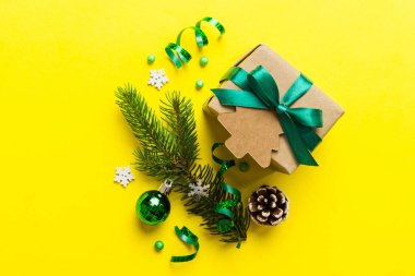 Top view Flat lay Christmas decorations and gift box on colored background with copy space. Christmas or Happy New Year composition.