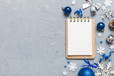 Christmas blank greeting card mock-up scene. Creative layout made of Christmas tree branches and paper card note. Flat lay. Nature New Year concept.