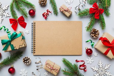 Christmas blank greeting card mock-up scene. Creative layout made of Christmas tree branches and paper card note. Flat lay. Nature New Year concept.