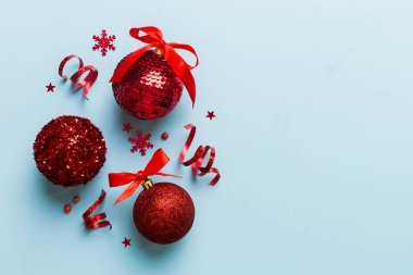 Christmas ball on colored background. decoration bauble with ribbon bow with copy space.