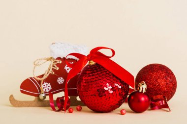 Christmas ball with skates on colored background. decoration bauble with ribbon bow with copy space.