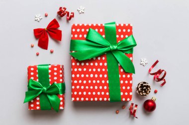 Top view Flat lay Christmas decorations and gift box on colored background with copy space. Christmas or Happy New Year composition.