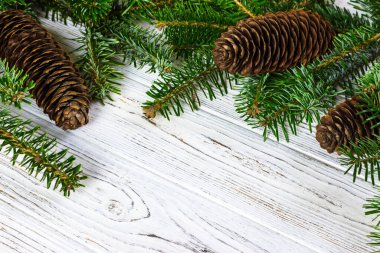 Köknar ağacı ahşap masa, Noel dekorasyon arka plan üzerinde çam kozalakları ile.