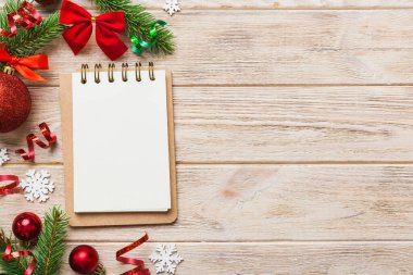 Christmas blank greeting card mock-up scene. Creative layout made of Christmas tree branches and paper card note. Flat lay. Nature New Year concept.