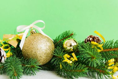 New Year Christmas tree toy, branches of a christmas tree, New Year decorations on a colored background.