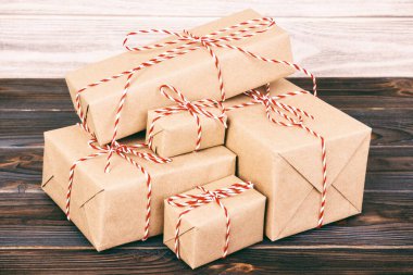 Kutuları kraft kağıdıyla birlikte gri arka plandaki ahşap masanın üzerine koyuyor. Ayarlanmış.