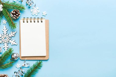 Christmas blank greeting card mock-up scene. Creative layout made of Christmas tree branches and paper card note. Flat lay. Nature New Year concept.