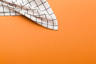 top view with white empty kitchen napkin isolated on table background. Folded cloth for mockup with copy space, Flat lay. Minimal style.