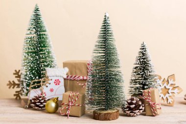 Christmas composition. Gifts, small tree, branches and craft DIY decorations on white background. New year concept. Christmas home decoration Flat lay, top view, copy space.