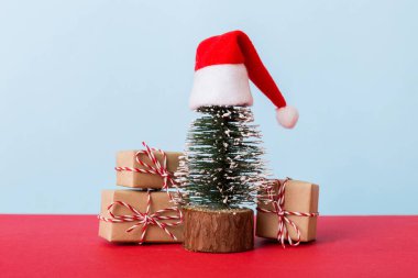 Christmas composition. Gifts, small tree, branches and craft DIY decorations on white background. New year concept. Christmas home decoration Flat lay, top view, copy space.