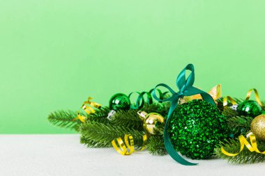 New Year Christmas tree toy, branches of a christmas tree, New Year decorations on a colored background.
