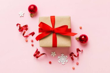 Top view Flat lay Christmas decorations and gift box on colored background with copy space. Christmas or Happy New Year composition.