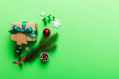 Top view Flat lay Christmas decorations and gift box on colored background with copy space. Christmas or Happy New Year composition.