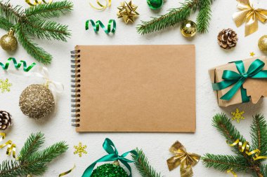 Christmas blank greeting card mock-up scene. Creative layout made of Christmas tree branches and paper card note. Flat lay. Nature New Year concept.