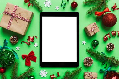 Digital tablet mock up with rustic Christmas decorations for app presentation top view with empty space for you design. Christmas online shopping concept. Tablet with copy space on colored background.