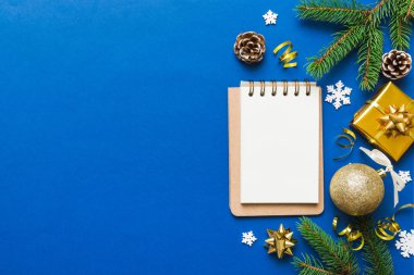 Christmas blank greeting card mock-up scene. Creative layout made of Christmas tree branches and paper card note. Flat lay. Nature New Year concept.