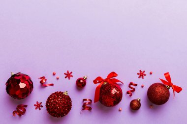 Christmas ball on colored background. decoration bauble with ribbon bow with copy space.