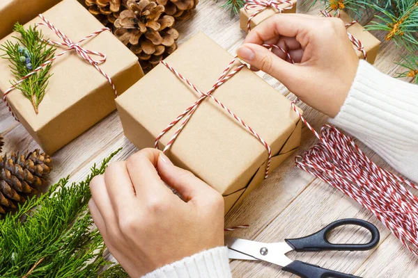 Gift wrapping. Woman packs gifts, wrapping step by step.