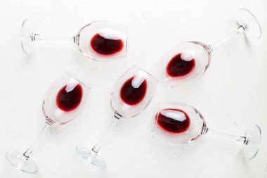 Şarap tadımında bir sürü kırmızı şarap. Renkli arka planda kırmızı şarap kavramı. Üst görünüm, düz dizayn.