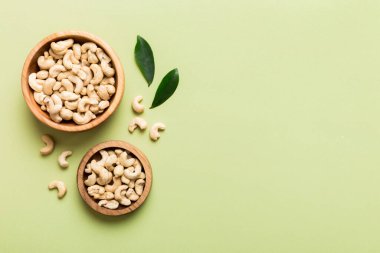 cashew nuts in wooden bowl on table background. top view. Space for text. Healthy food