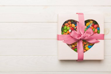 Box with sweet chocolate candies on color background, Various candy sweets. Valentines day gift box. Top view flat lay with copy space.