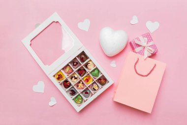 Valentine day composition: sweet candy, with gift boxes with bow and red felt hearts, photo template, background. Top View with copy space.