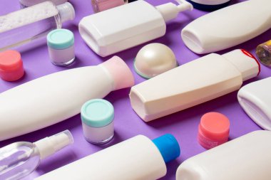 Plastik gövde bakımı şişesi düz kompozisyonu ve renkli arka plan boşluğuna kozmetik ürünler dizayn edilmişti. Beyaz Kozmetik kapları kümesi, kopya alanı ile üst görünüm.