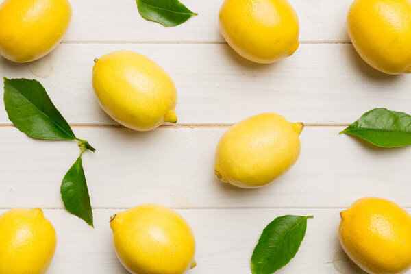 Many fresh ripe lemons as colored background, top view. Elegant background of lemon and lemon slices Top view flat lay.