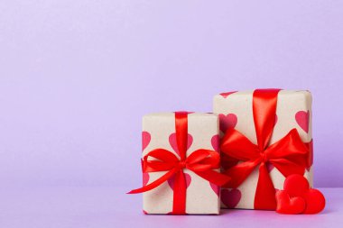 Valentine day composition: sweet candy, with gift boxes with bow and red felt hearts, photo template, background. Perspective with copy space.
