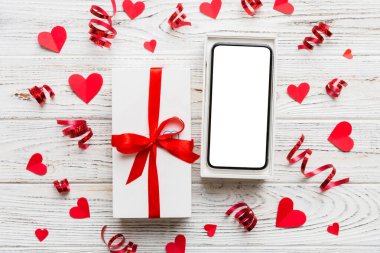 Opened gift box with ribbon and phone on color background, top view. Blank open box packaging mockup , Template for your design - branding mockup.