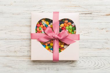 Box with sweet chocolate candies on color background, Various candy sweets. Valentines day gift box. Top view flat lay with copy space.