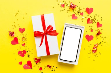 Opened gift box with ribbon and phone on color background, top view. Blank open box packaging mockup , Template for your design - branding mockup.