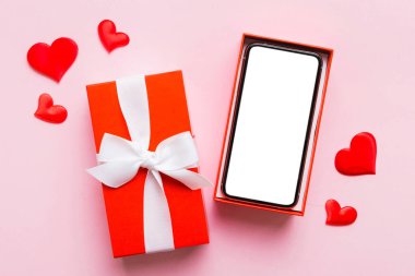 Opened gift box with ribbon and phone on color background, top view. Blank open box packaging mockup , Template for your design - branding mockup.