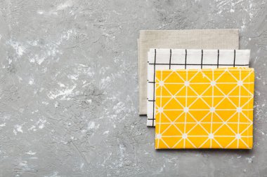 top view with yellow empty kitchen napkin isolated on table background. Folded cloth for mockup with copy space, Flat lay. Minimal style.