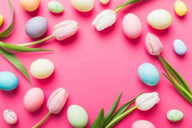 Mutlu Paskalya kompozisyonu. Renkli masada sarı laleli Paskalya yumurtaları. Doğal boyalı renkli yumurtalar arkaplan arkaplan görünümü kopya alanı ile.
