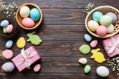 Yumurtalı Paskalya çerçevesi, renkli bir arka planda hediye kutusu ve lale. Minimum konsept. Üst Manzara Mutlu Paskalyalar kompozisyonu. Metin için yerin bir kopyasına sahip kart.